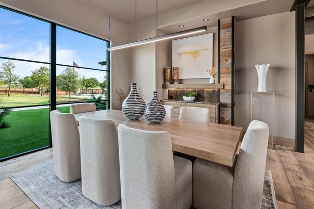 a dining room with furniture and a large window
