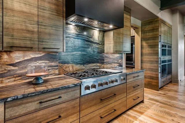 a stove top oven sitting inside of a kitchen