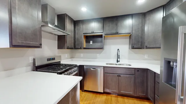 a kitchen with a sink a stove and cabinets