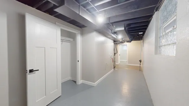 a view of a hallway with wooden shelves