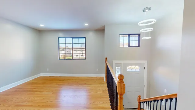 a view of a room with wooden floor and window