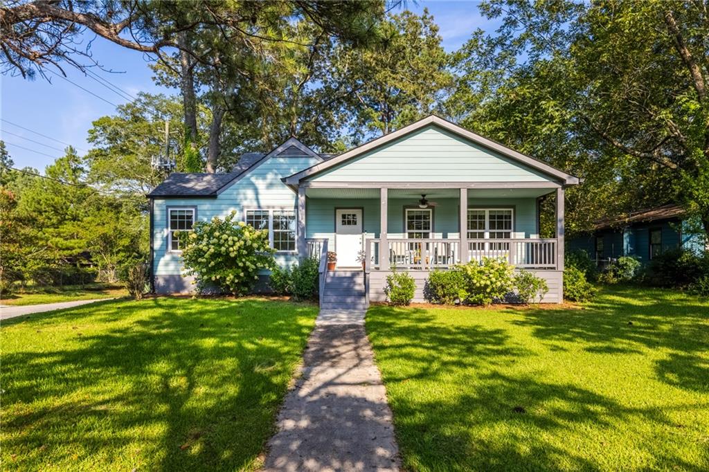 3074 Old Jonesboro Road Atlanta, GA 30354 - Photo 1 of 1 a front view of a house with a yard table and chairs