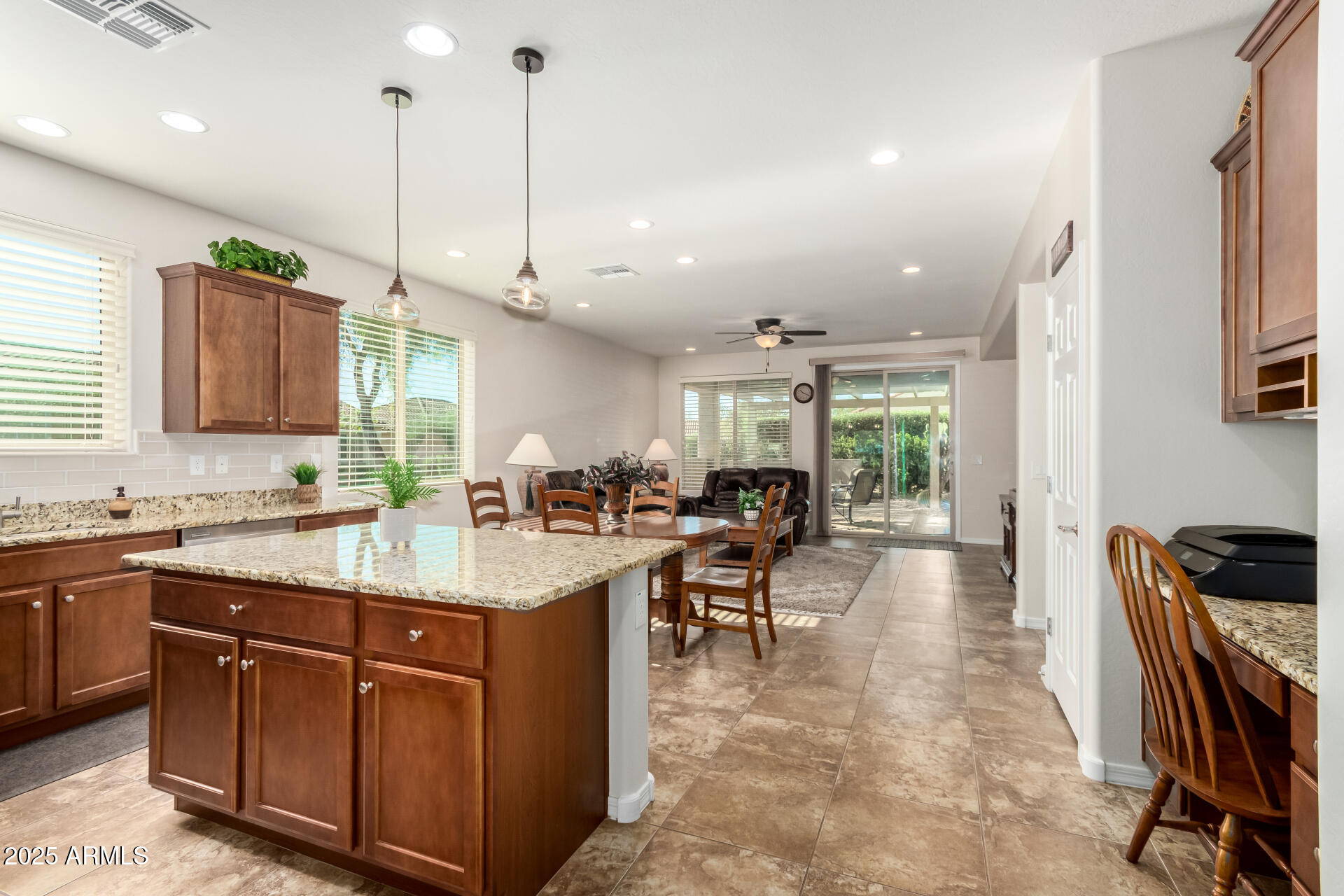 a kitchen with counter top space appliances and a view of living room