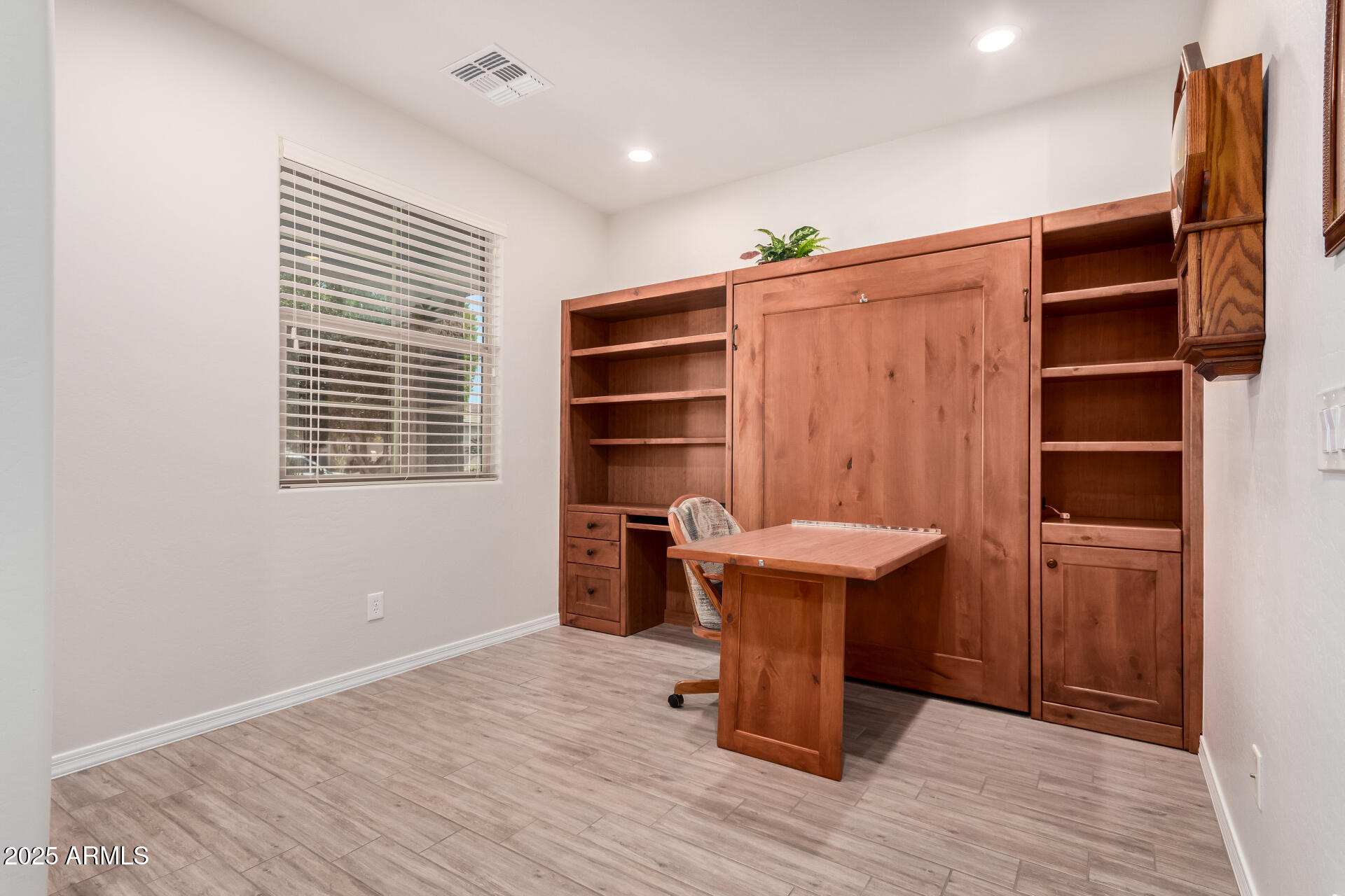 7253 West Cinder Brook Way Florence, AZ 85132 - Photo 12 of 72 a view of a room with cabinets and wooden floor