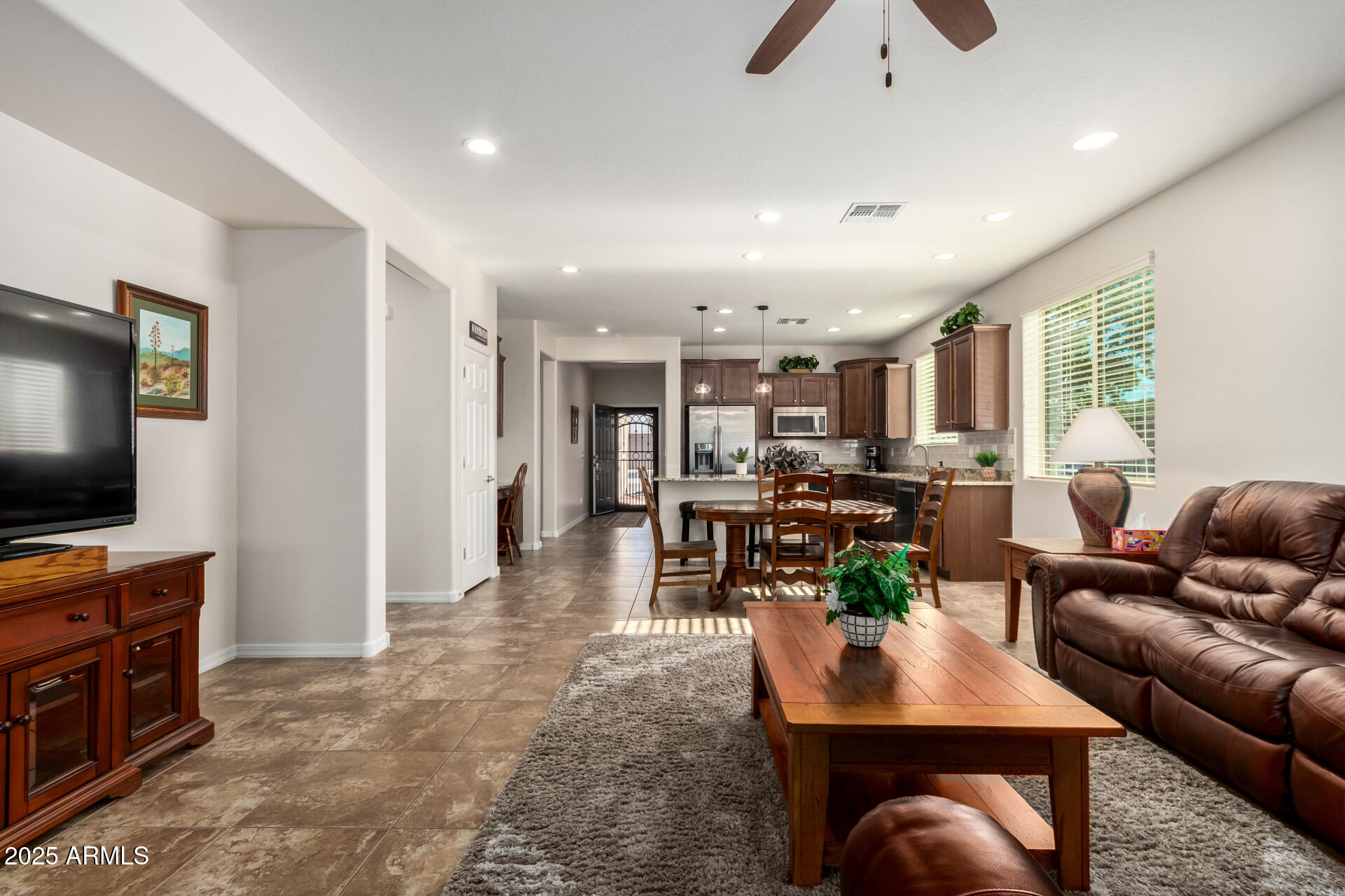 7253 West Cinder Brook Way Florence, AZ 85132 - Photo 16 of 72 a living room with furniture and a flat screen tv