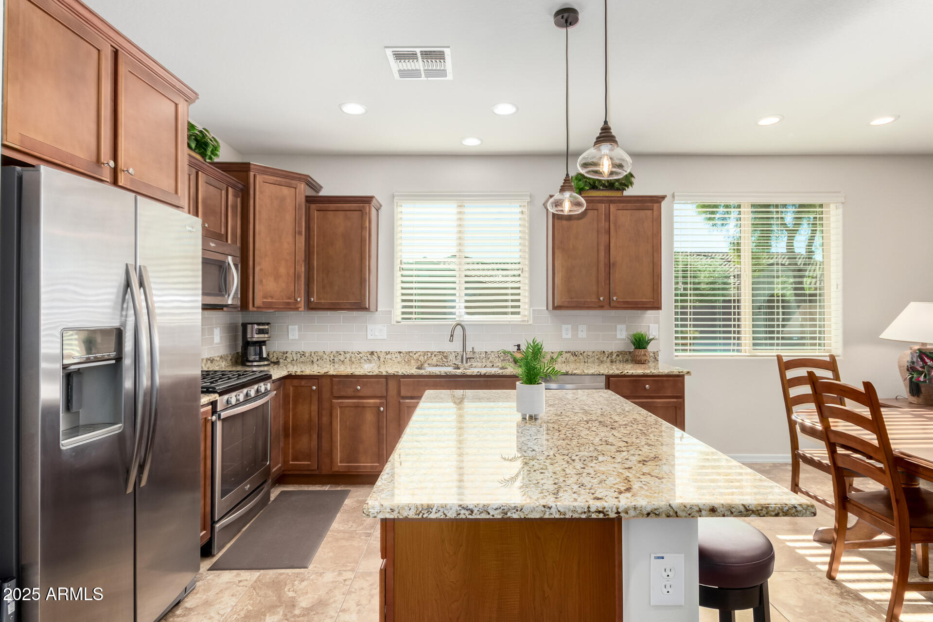 7253 West Cinder Brook Way Florence, AZ 85132 - Photo 18 of 72 a kitchen with stainless steel appliances granite countertop sink stove refrigerator and cabinets