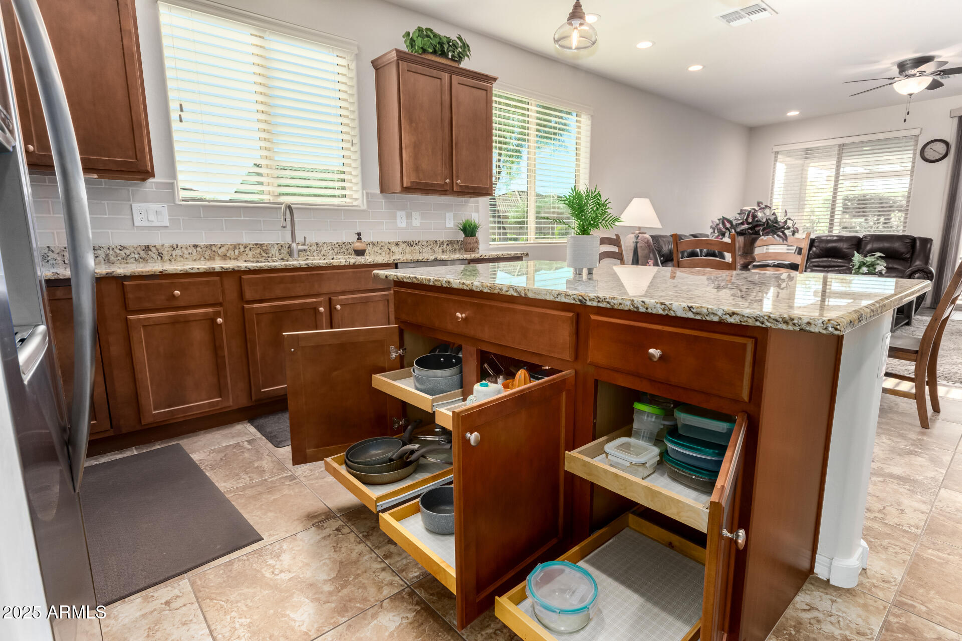 7253 West Cinder Brook Way Florence, AZ 85132 - Photo 21 of 72 a kitchen with granite countertop a sink stove and cabinets
