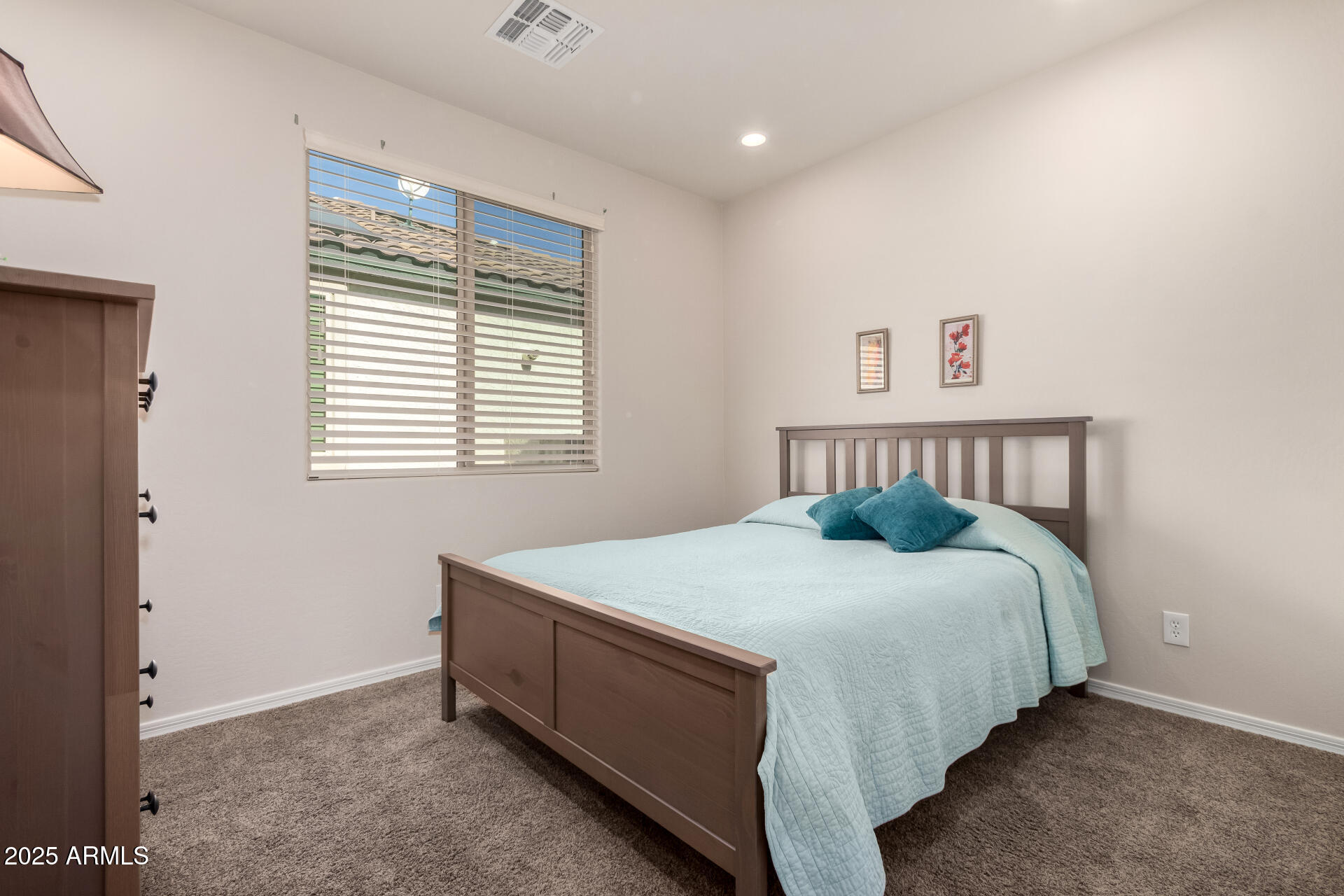 7253 West Cinder Brook Way Florence, AZ 85132 - Photo 27 of 72 a bed sitting in a bedroom next to a window
