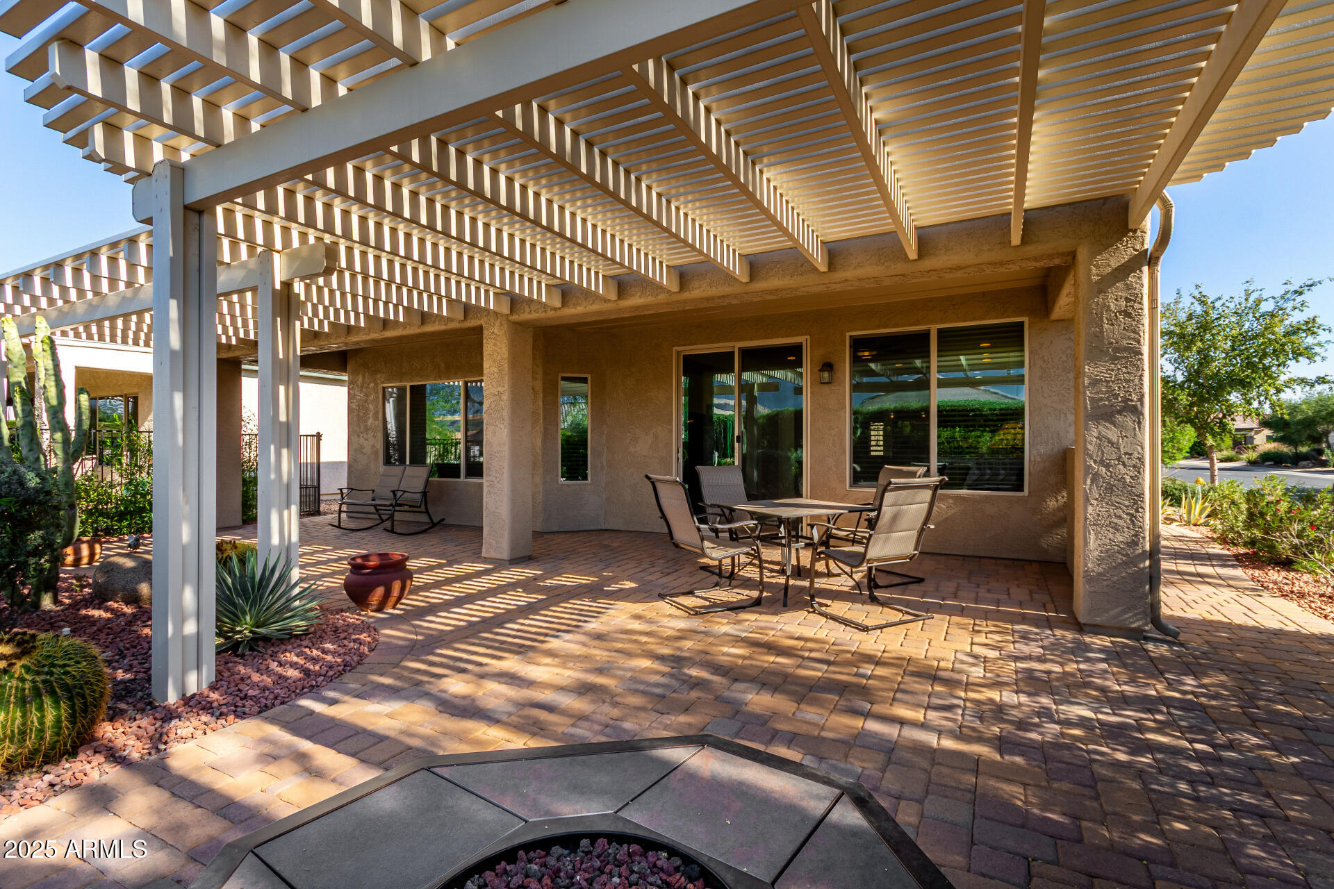 7253 West Cinder Brook Way Florence, AZ 85132 - Photo 32 of 72 a view of a patio with a table and chairs under an umbrella