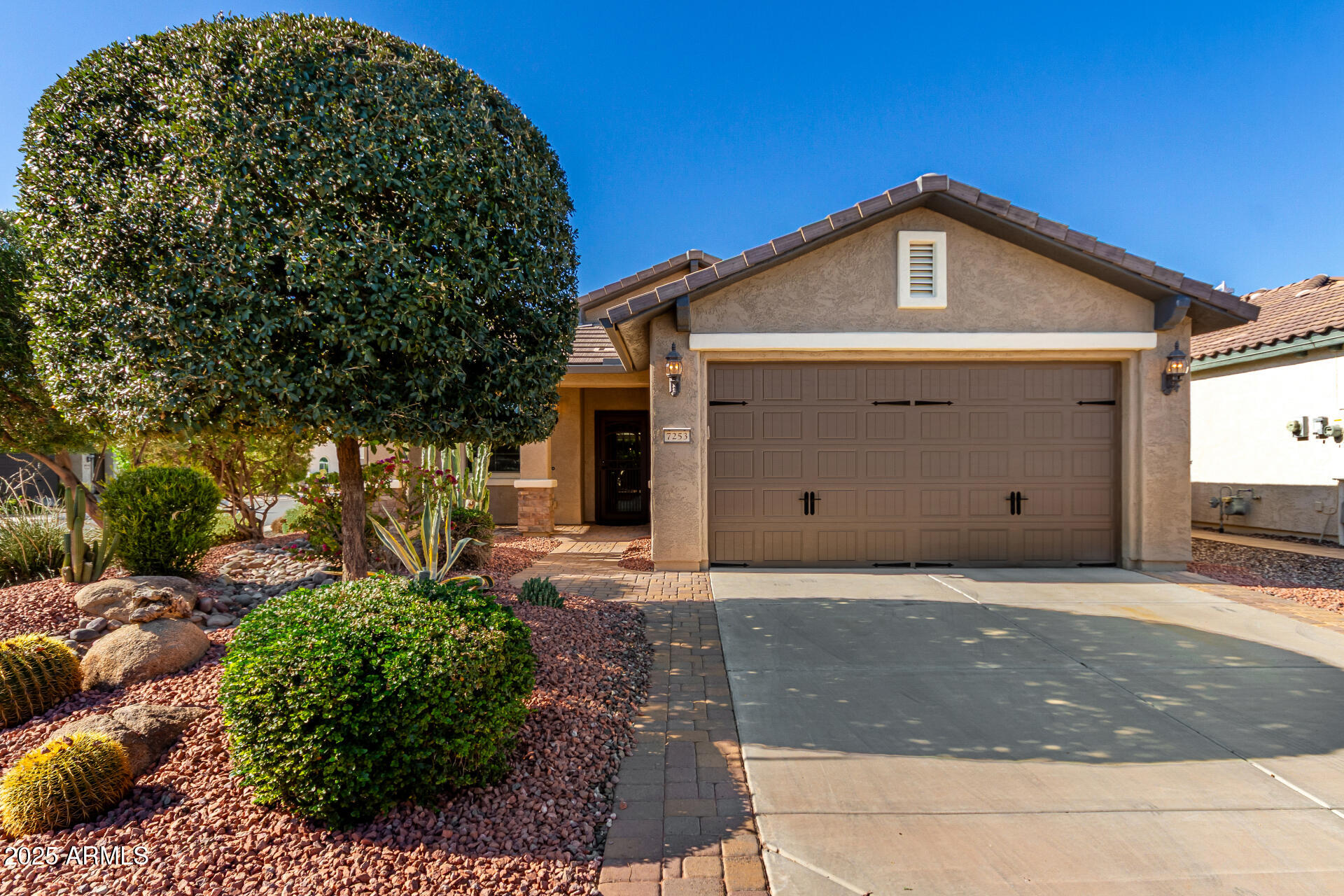 7253 West Cinder Brook Way Florence, AZ 85132 - Photo 4 of 72 a front view of a house with a garage