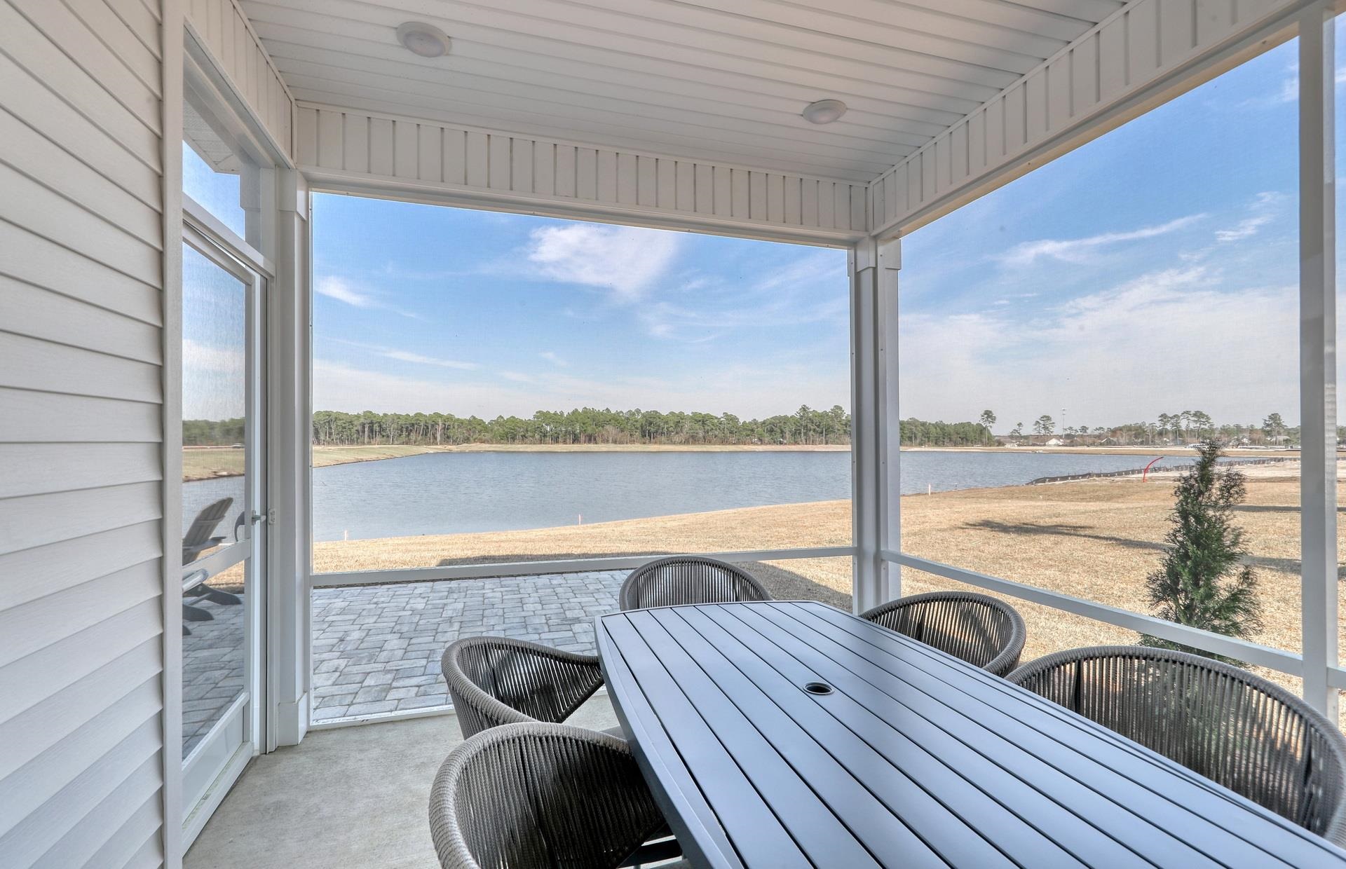 803 Laconic Drive Myrtle Beach, SC 29588 - Photo 18 of 21 View of patio with a sunroom, a water view, and outdoor dining area