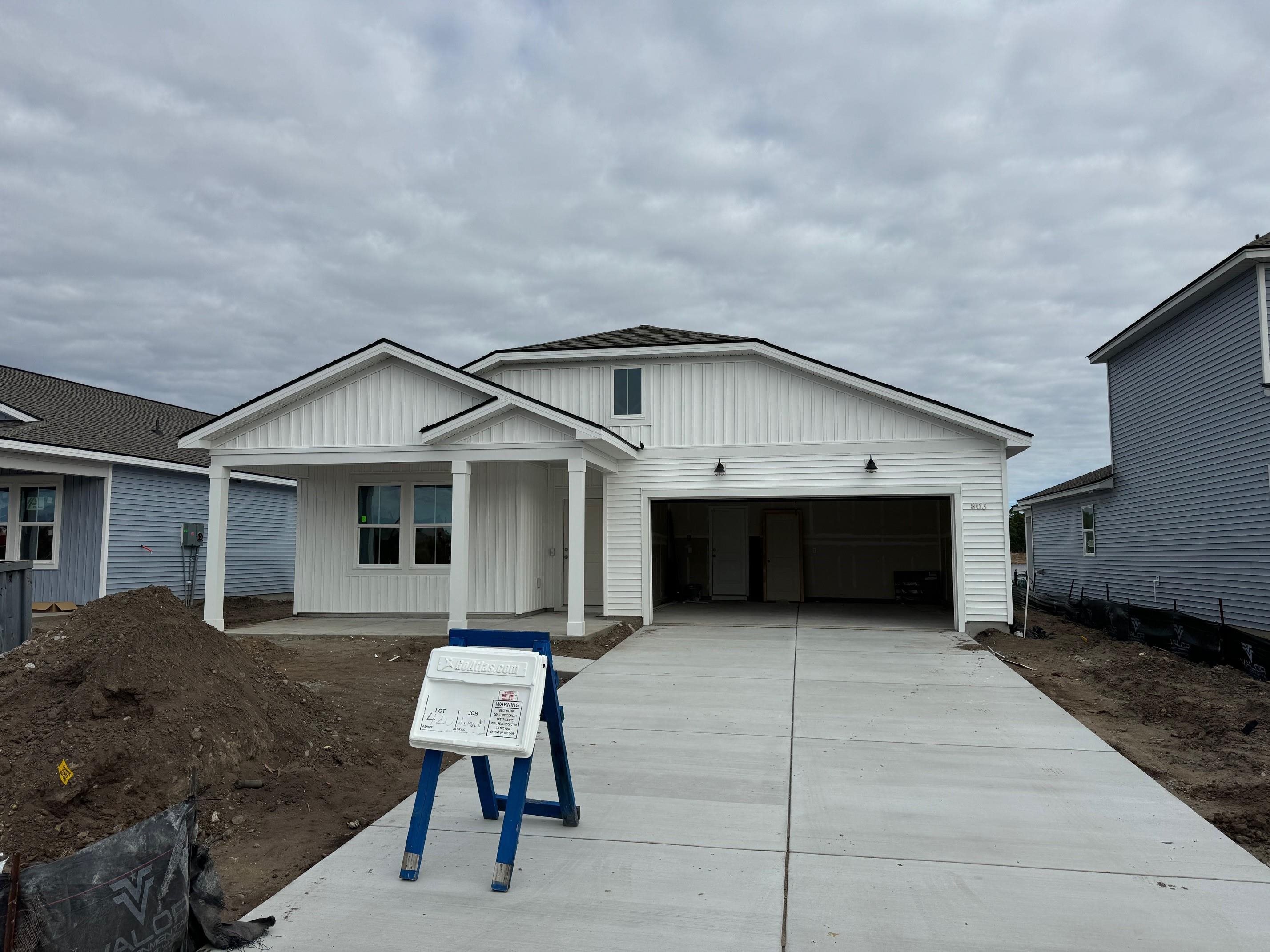 803 Laconic Drive Myrtle Beach, SC 29588 - Photo 2 of 21 View of front of home with concrete driveway, a garage, and a porch