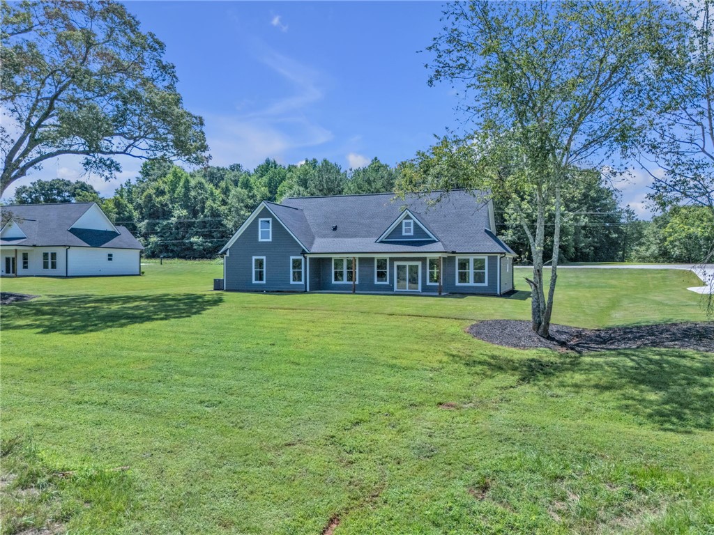 1725 Harris Bridge Road Anderson, SC 29621 - Photo 28 of 33 A well-maintained residence sits on a generous lot, offering ample green space and a serene natural setting.