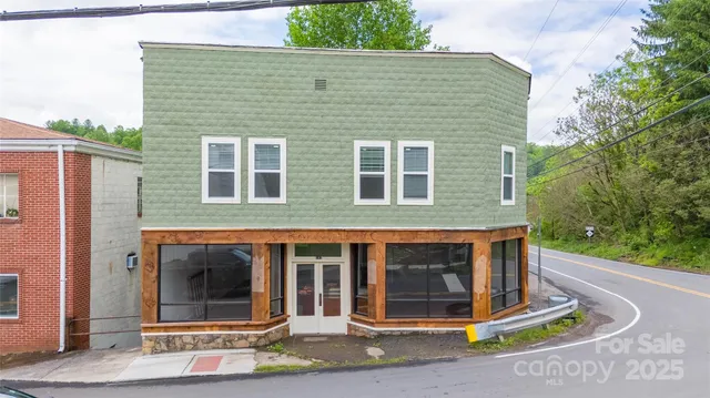 a view of a brick house with large windows