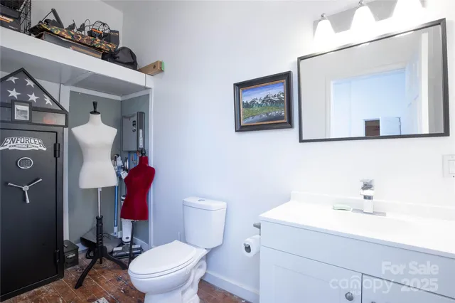 a bathroom with a toilet sink and mirror