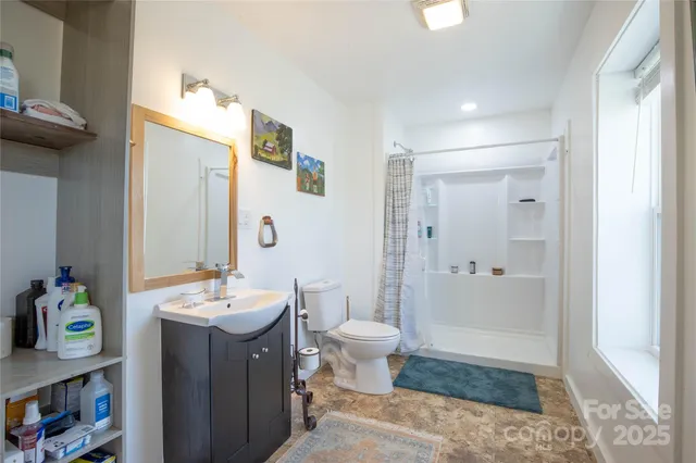 a spacious bathroom with a sink a toilet and shower