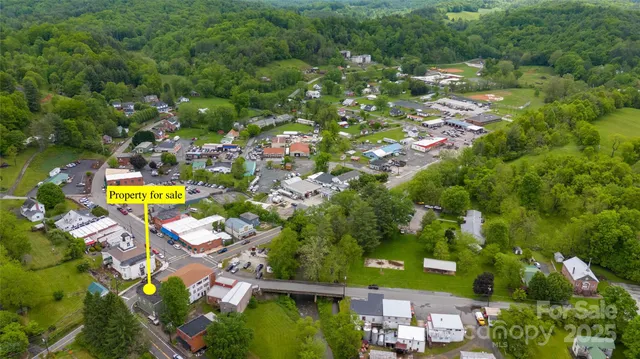 an aerial view of residential houses with outdoor space and swimming pool