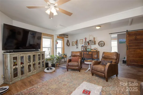 a living room with furniture and a flat screen tv