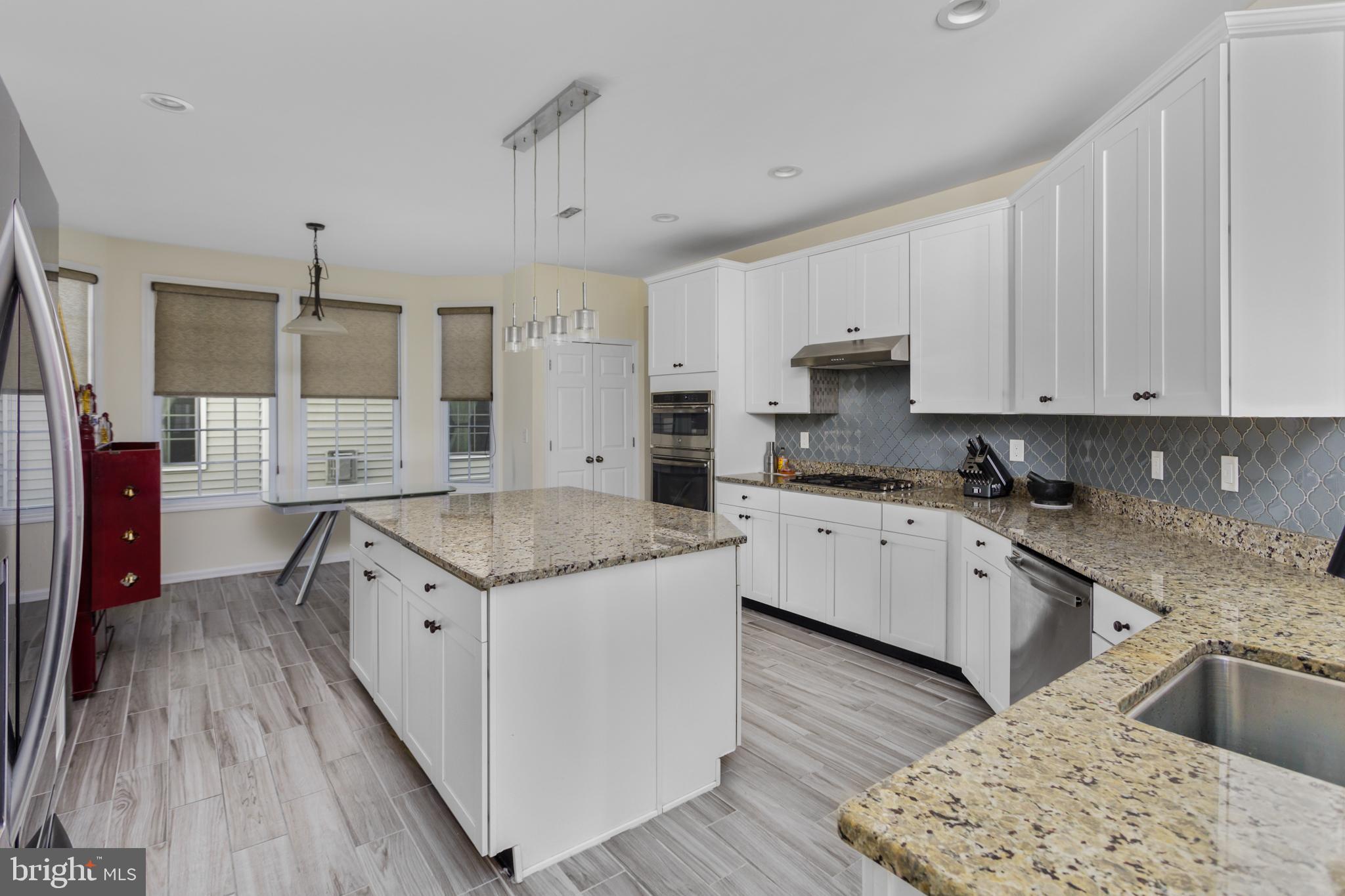 36 Brookdale Way Chesterfield, NJ 08515 - Photo 16 of 52 a kitchen with granite countertop a sink stove and refrigerator