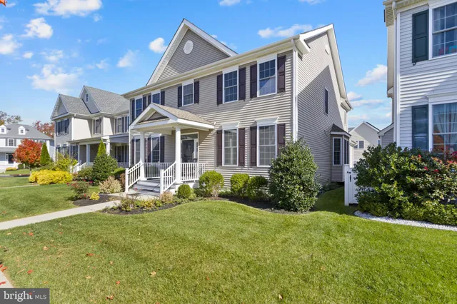 a front view of a house with garden and porch