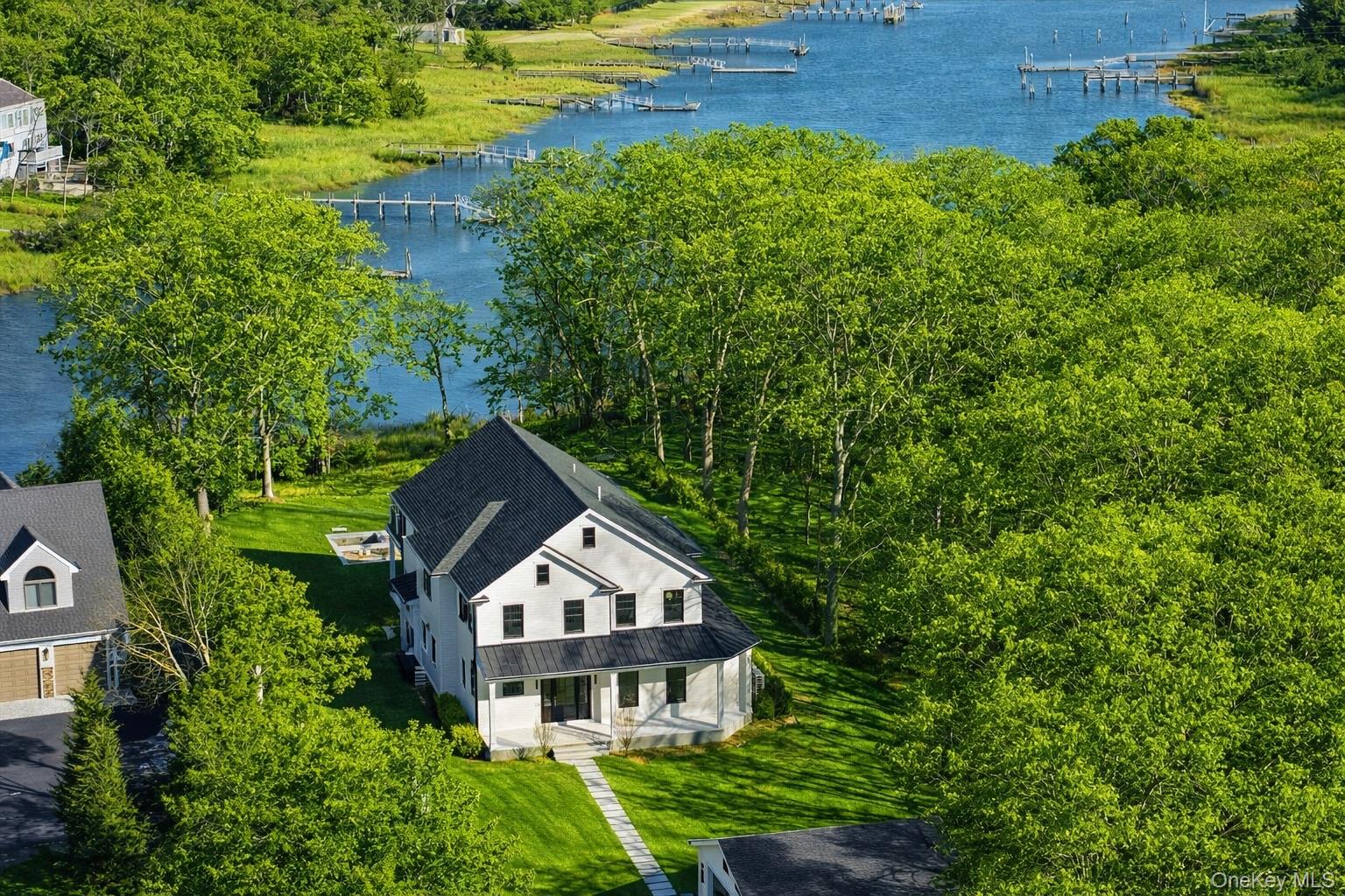 2590 Cox Neck Road Mattituck, NY 11952 - Photo 1 of 50 A striking waterfront estate set on 1.33 acres along coveted Mattituck Inlet,blending timeless architecture with refined modern luxury