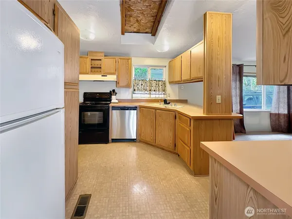 a kitchen with a sink stove and refrigerator