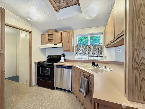 a kitchen with stainless steel appliances granite countertop a sink and a stove