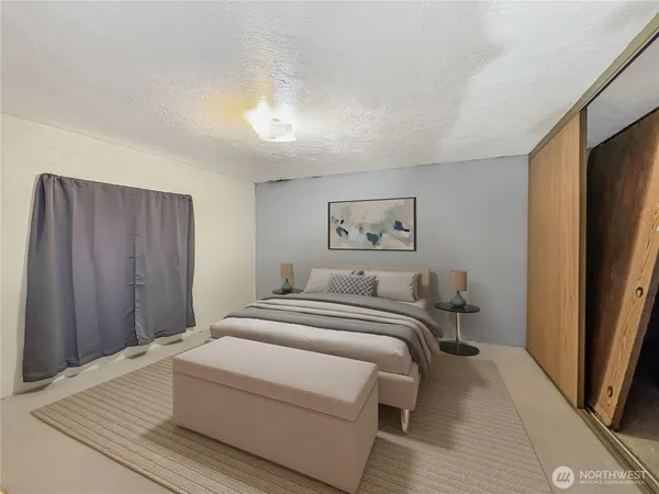 a bedroom with a bed and a painting on the wall