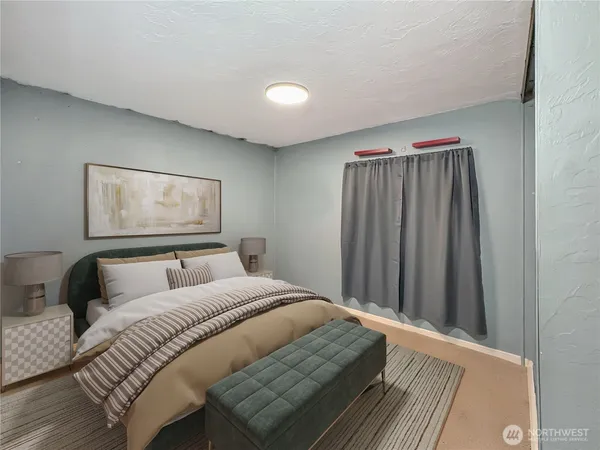 a bedroom with a bed and a painting on the wall