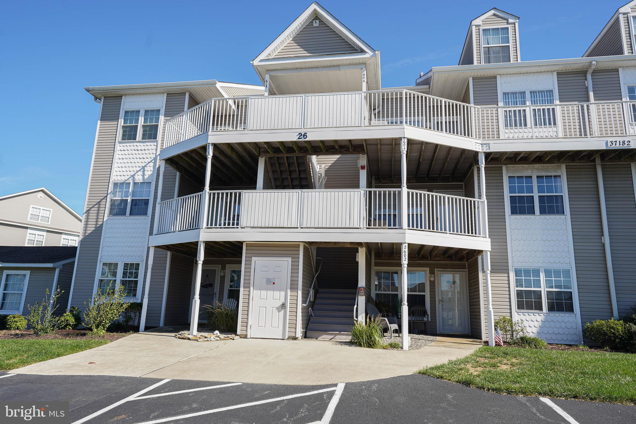 37182 Harbor Drive, Unit 264 Ocean View, DE 19970 - Photo 1 of 55 a front view of a building with a garden