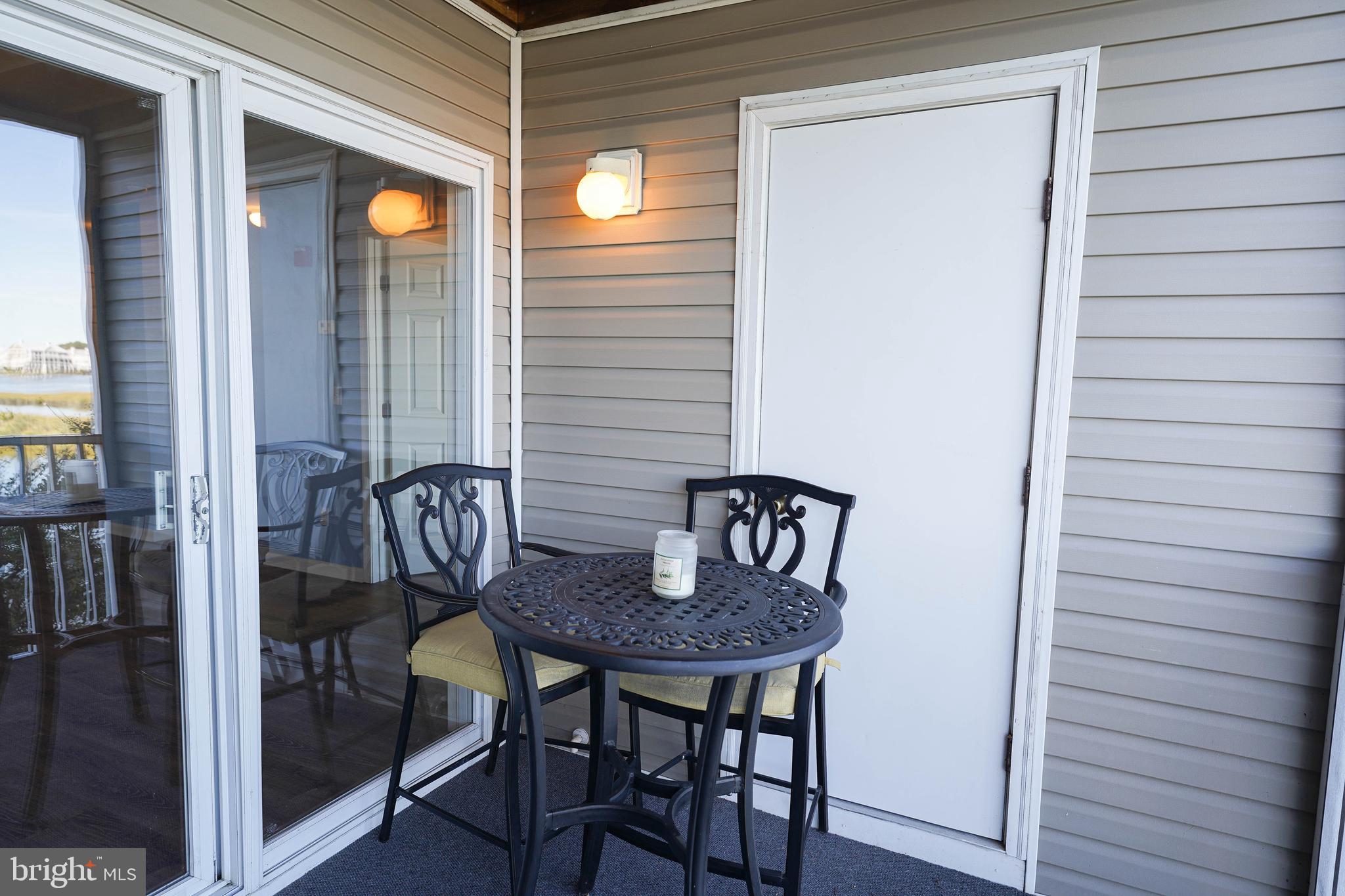 37182 Harbor Drive, Unit 264 Ocean View, DE 19970 - Photo 21 of 55 a table and chairs in a balcony