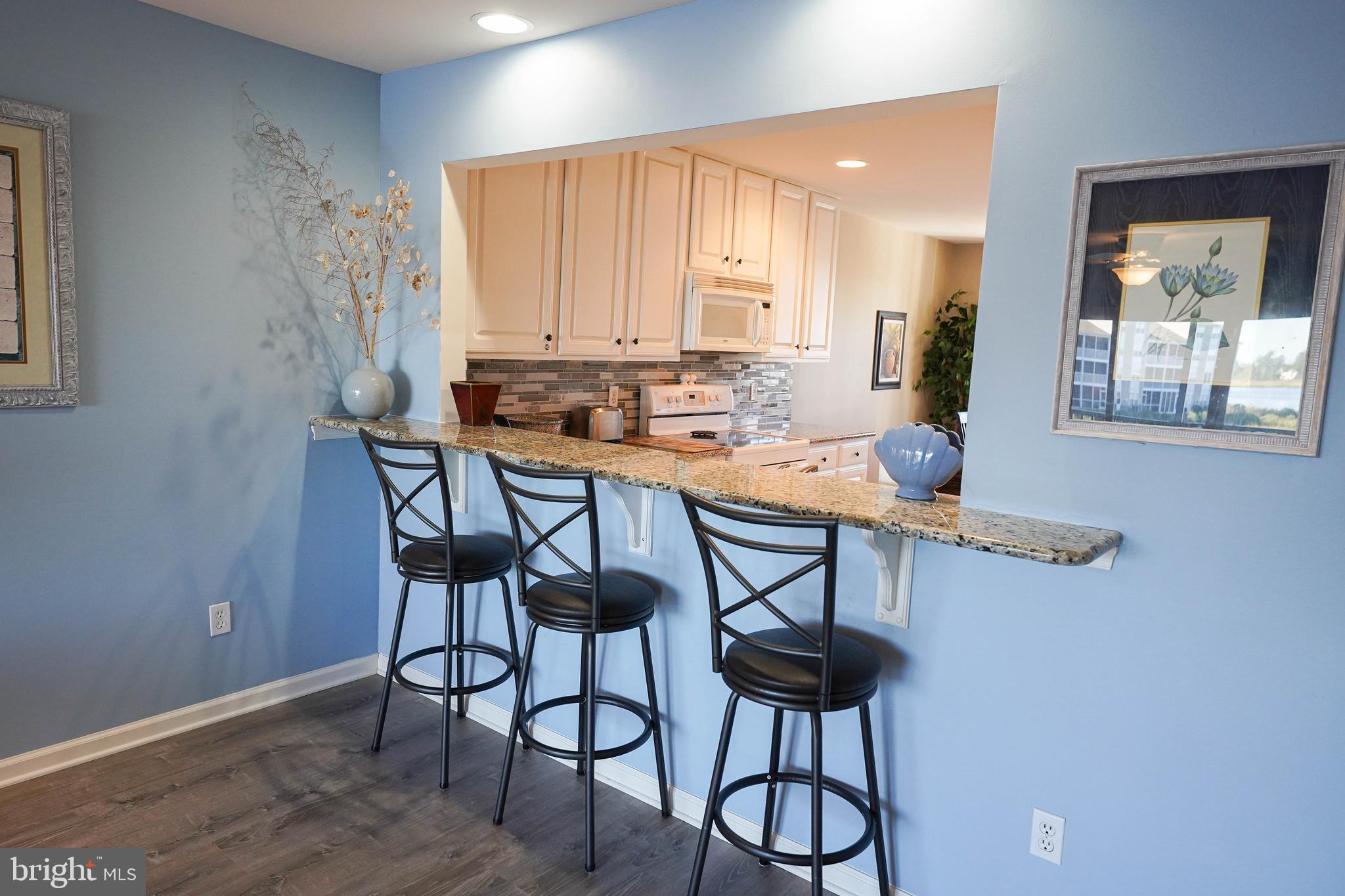37182 Harbor Drive, Unit 264 Ocean View, DE 19970 - Photo 22 of 55 a kitchen with stainless steel appliances a table and chairs in it