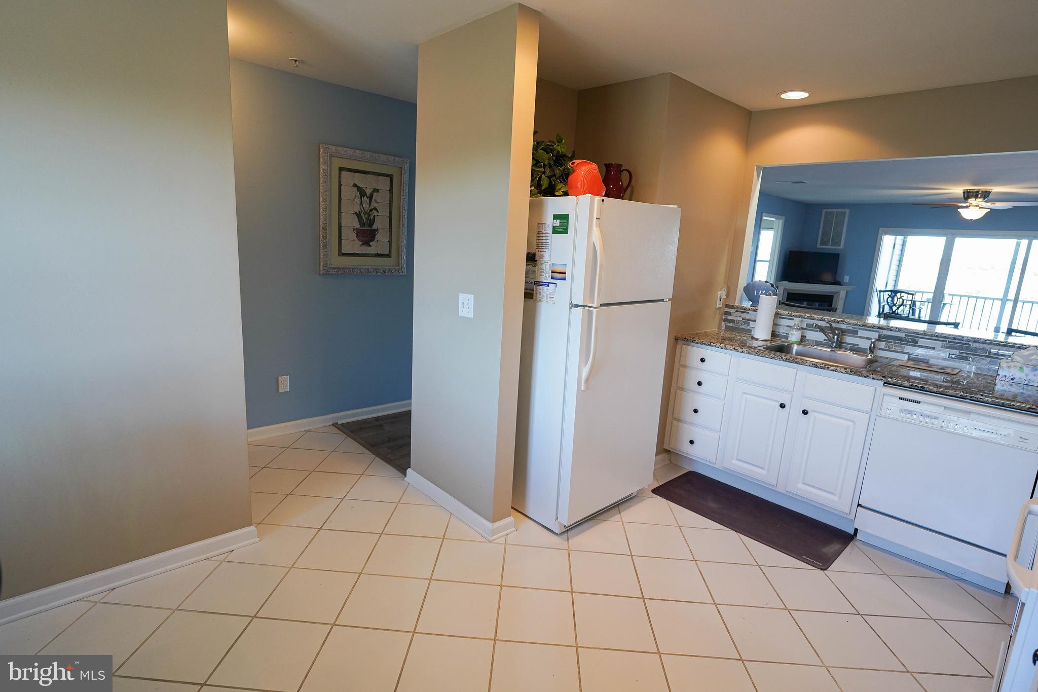 37182 Harbor Drive, Unit 264 Ocean View, DE 19970 - Photo 27 of 55 a kitchen with a refrigerator and white cabinets