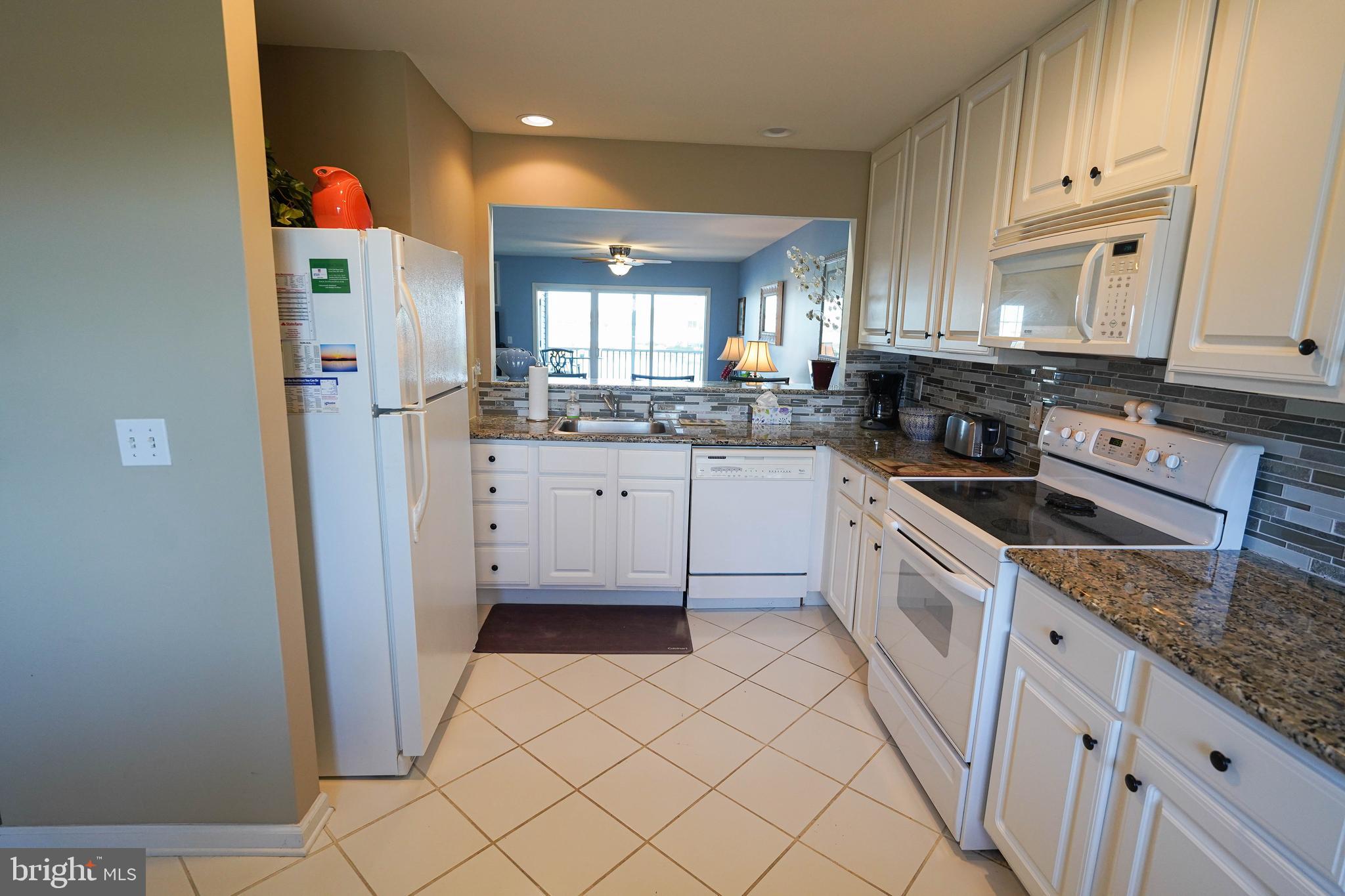 37182 Harbor Drive, Unit 264 Ocean View, DE 19970 - Photo 29 of 55 a kitchen with a sink a stove top oven and cabinetry