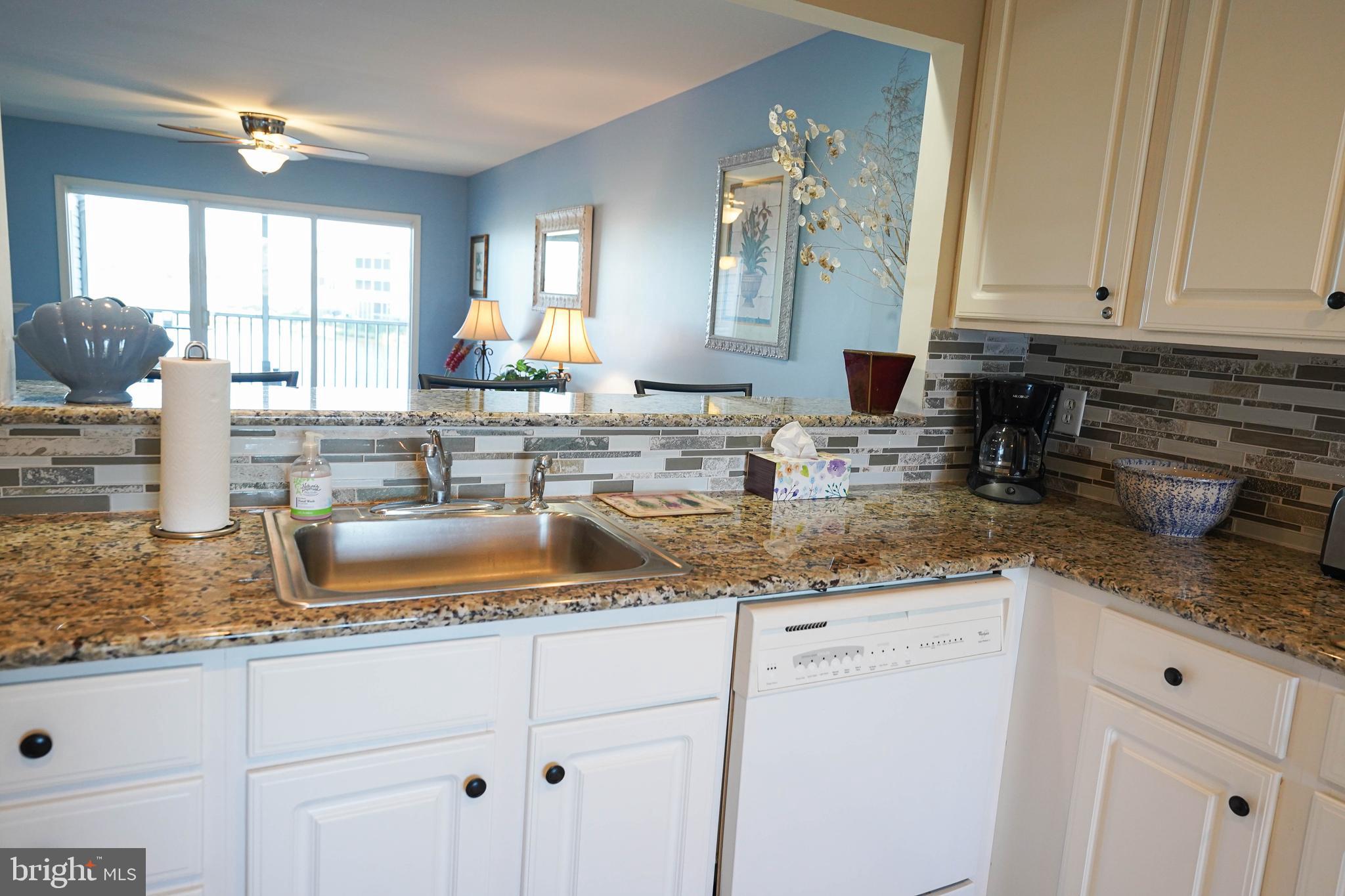 37182 Harbor Drive, Unit 264 Ocean View, DE 19970 - Photo 30 of 55 a kitchen with granite countertop a sink a stove and cabinets