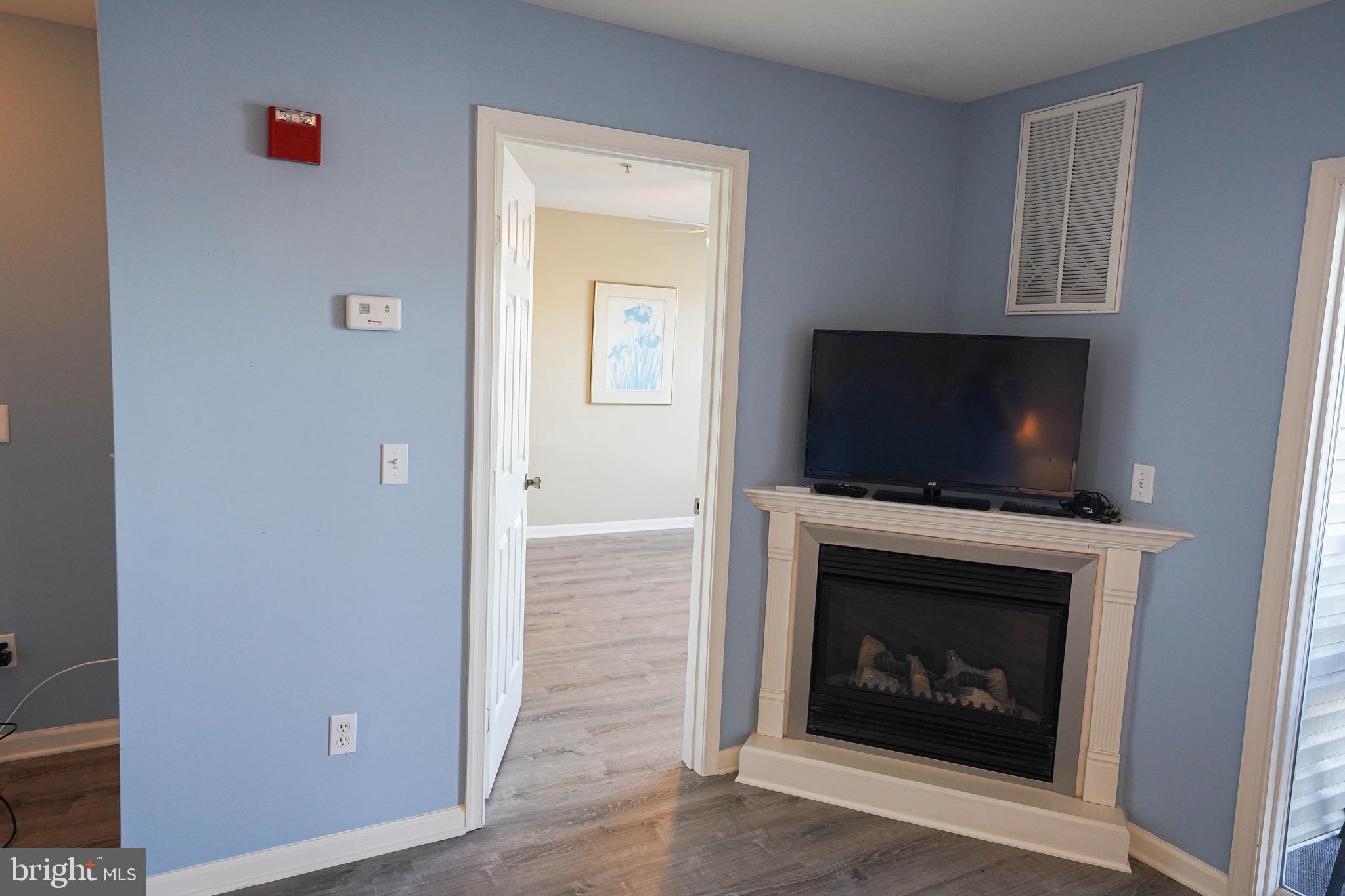 37182 Harbor Drive, Unit 264 Ocean View, DE 19970 - Photo 33 of 55 a living room with a fireplace and a flat screen tv