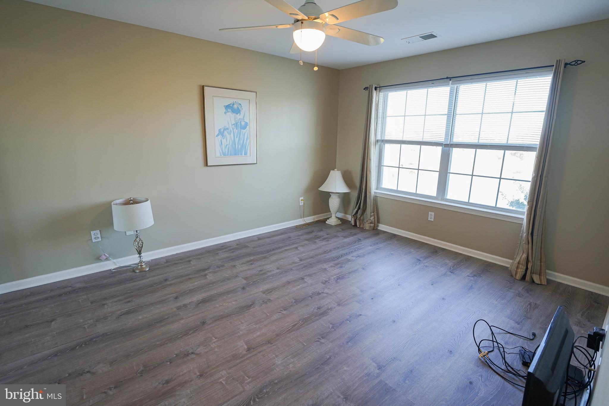 37182 Harbor Drive, Unit 264 Ocean View, DE 19970 - Photo 34 of 55 wooden floor in an empty room with a window
