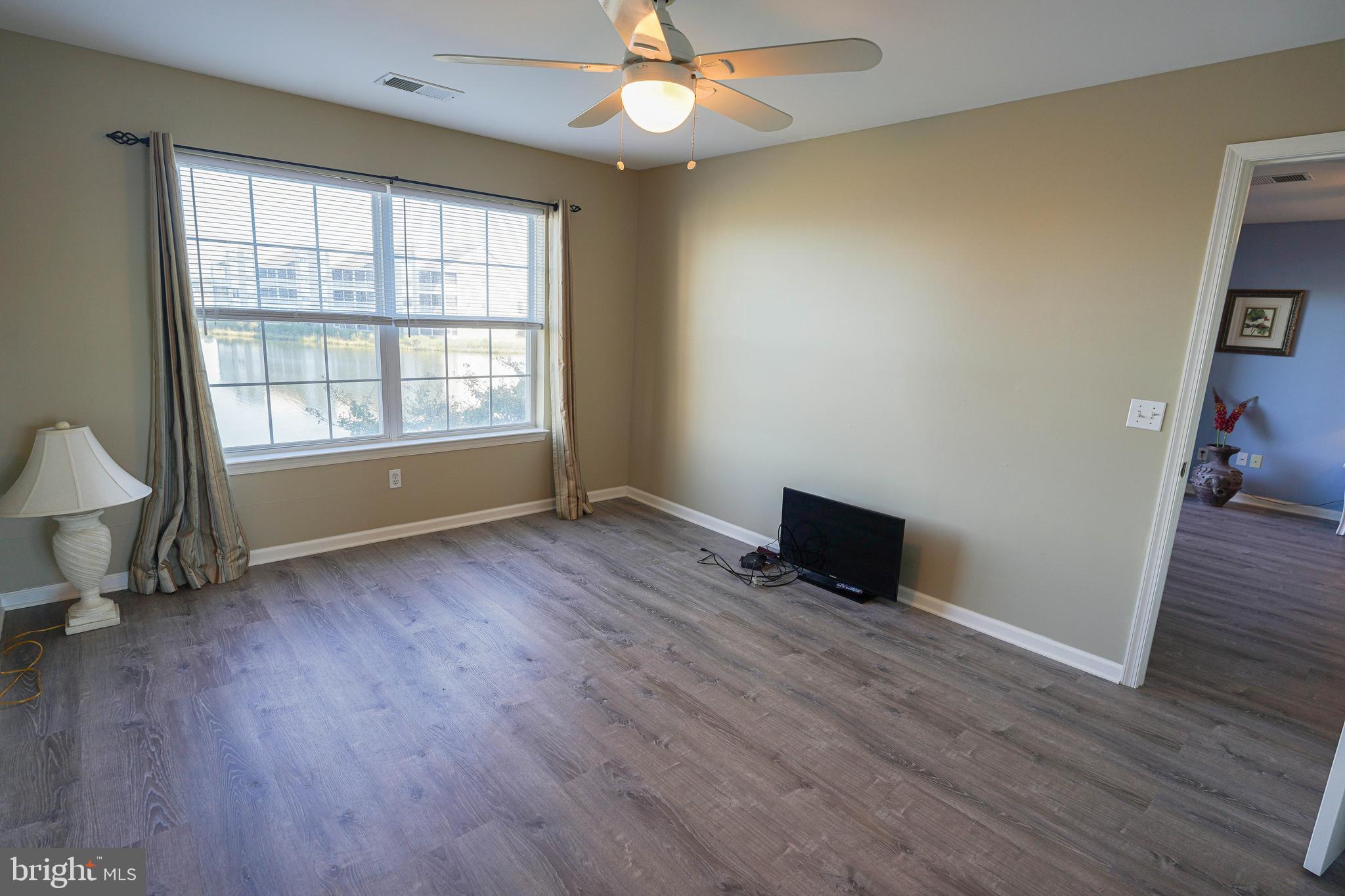 37182 Harbor Drive, Unit 264 Ocean View, DE 19970 - Photo 35 of 55 an empty room with wooden floor and windows