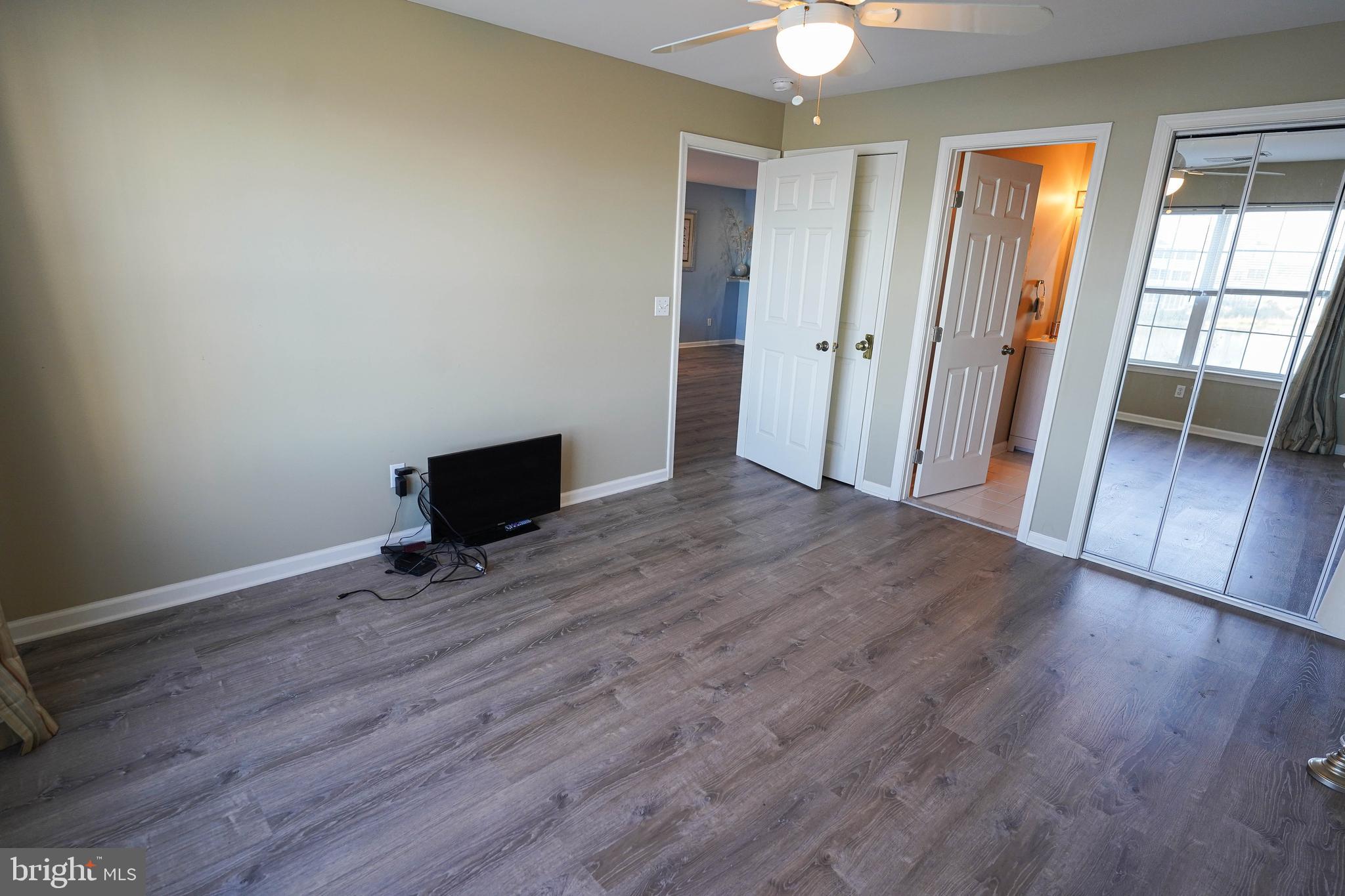 37182 Harbor Drive, Unit 264 Ocean View, DE 19970 - Photo 36 of 55 an empty room with wooden floor and a window