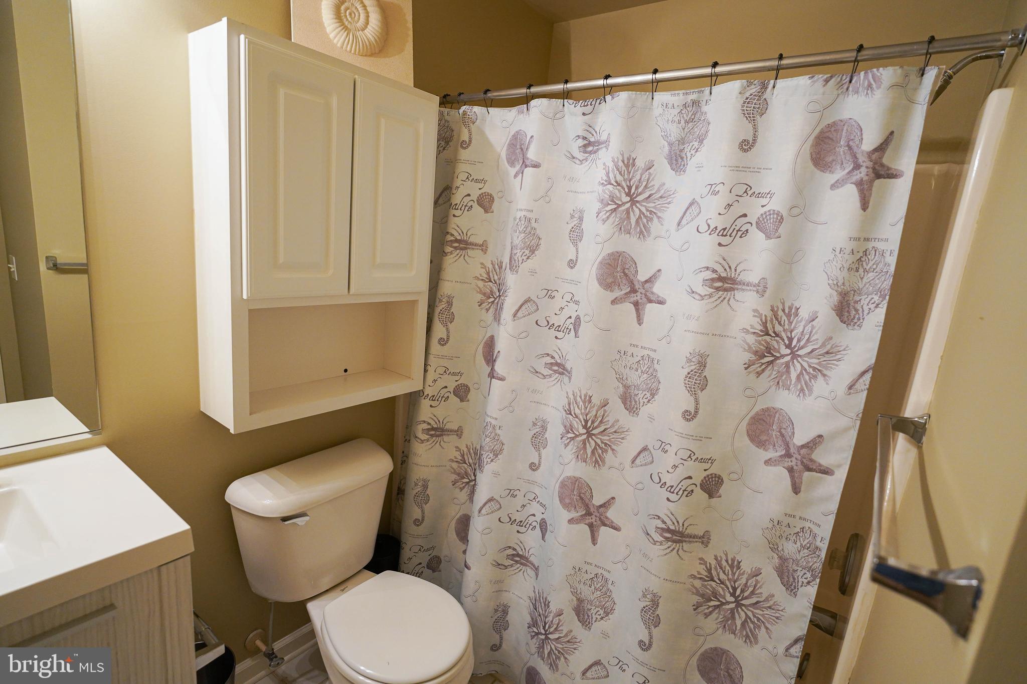 37182 Harbor Drive, Unit 264 Ocean View, DE 19970 - Photo 38 of 55 a white toilet sitting next to a shower curtain