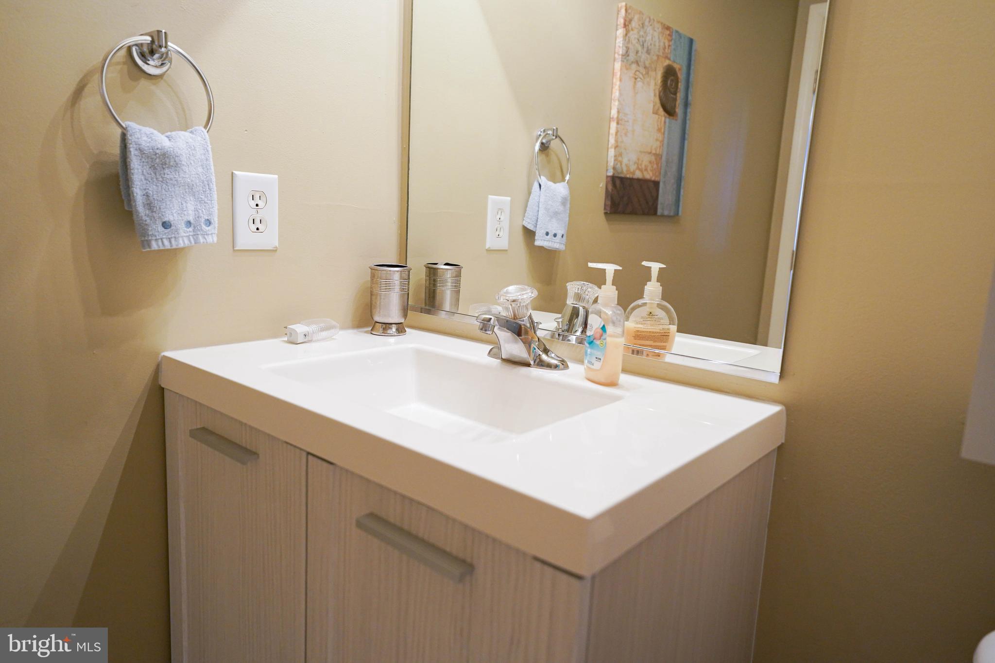 37182 Harbor Drive, Unit 264 Ocean View, DE 19970 - Photo 42 of 55 a bathroom with a sink and a mirror