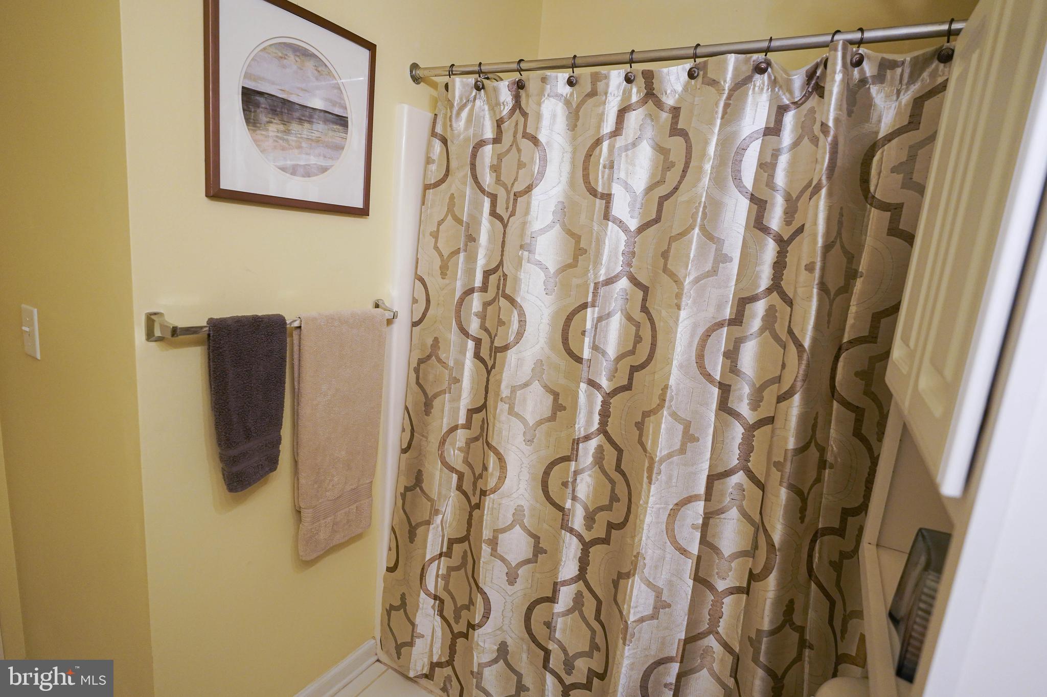 37182 Harbor Drive, Unit 264 Ocean View, DE 19970 - Photo 51 of 55 a bathroom with a shower curtain and a shower curtain