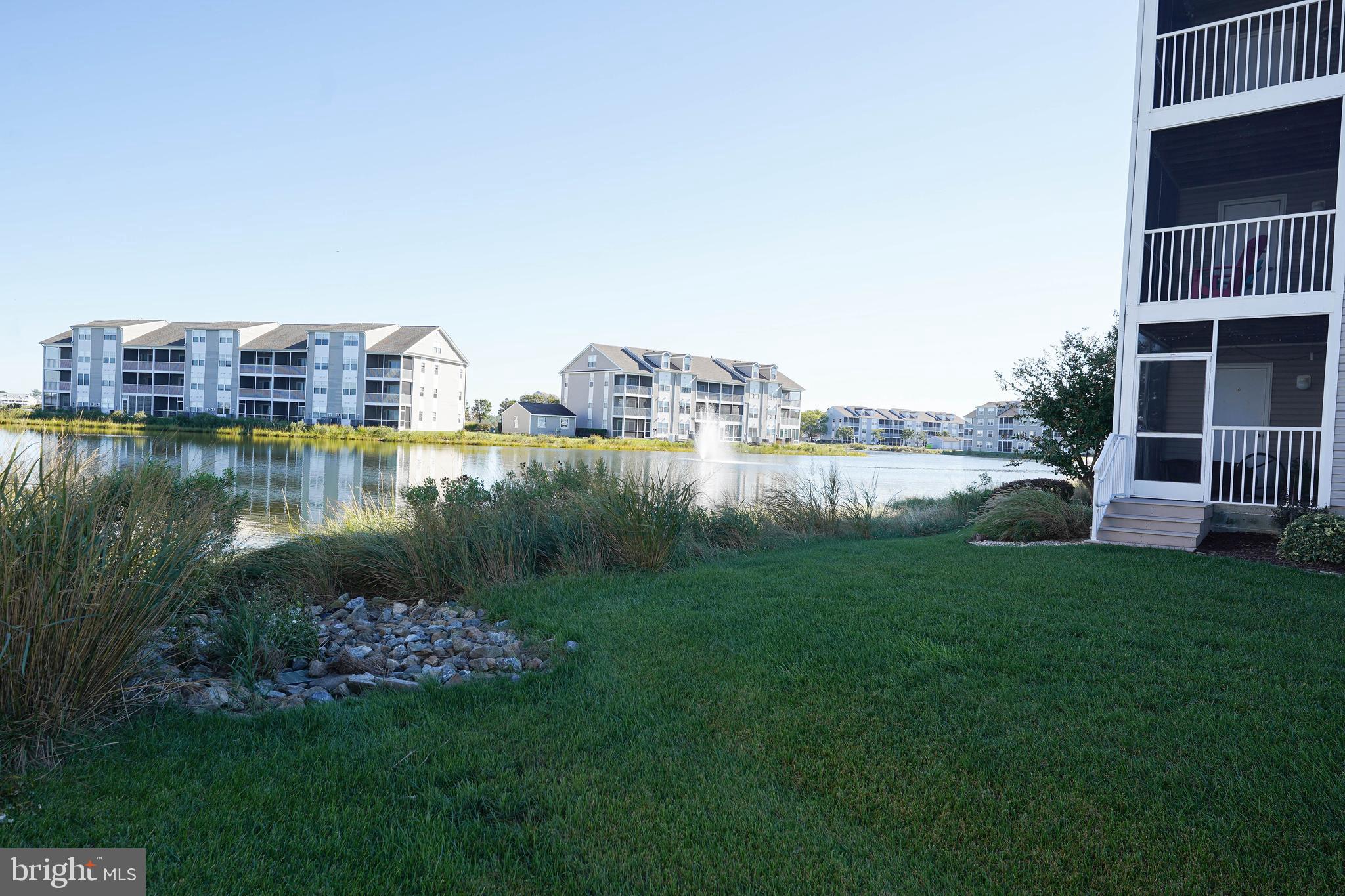 37182 Harbor Drive, Unit 264 Ocean View, DE 19970 - Photo 54 of 55 a view of a house with a yard and a pond