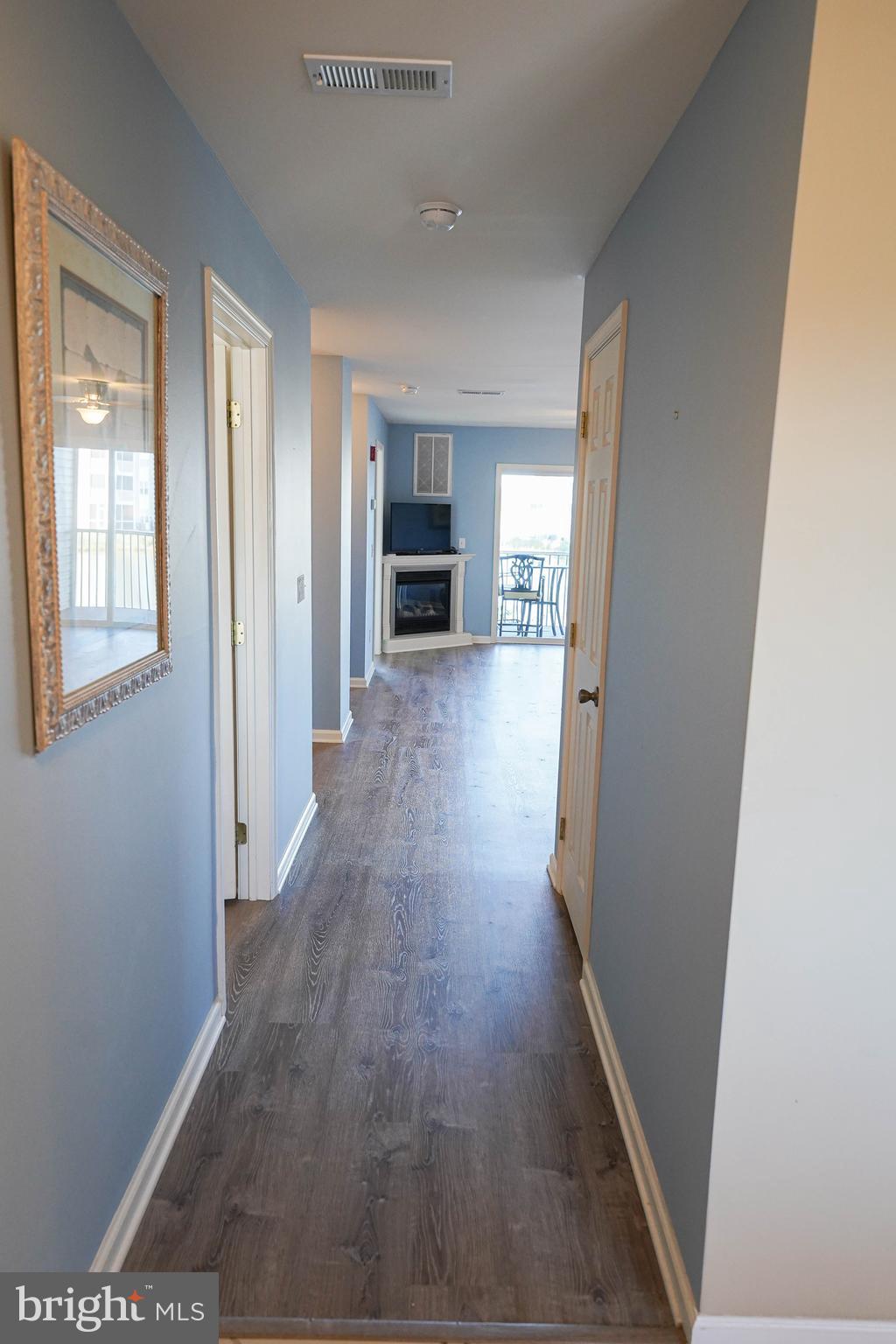 37182 Harbor Drive, Unit 264 Ocean View, DE 19970 - Photo 9 of 55 an empty room with wooden floor and fireplace