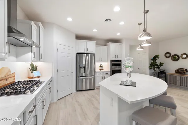 a kitchen with stainless steel appliances granite countertop a stove and a refrigerator