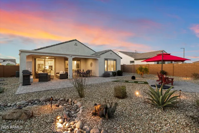 a view of a house with backyard porch and sitting area