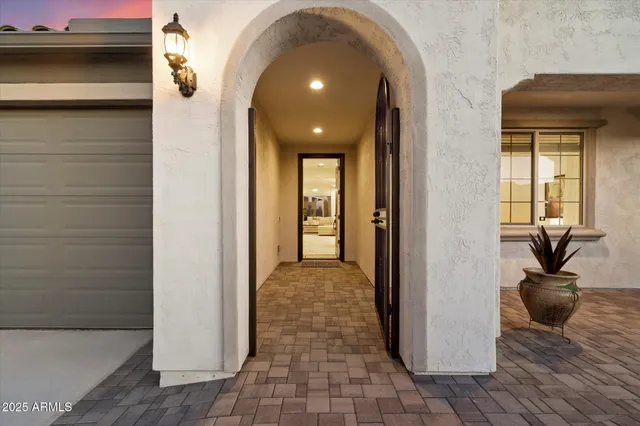 a view of a hallway with wooden floor and a living room