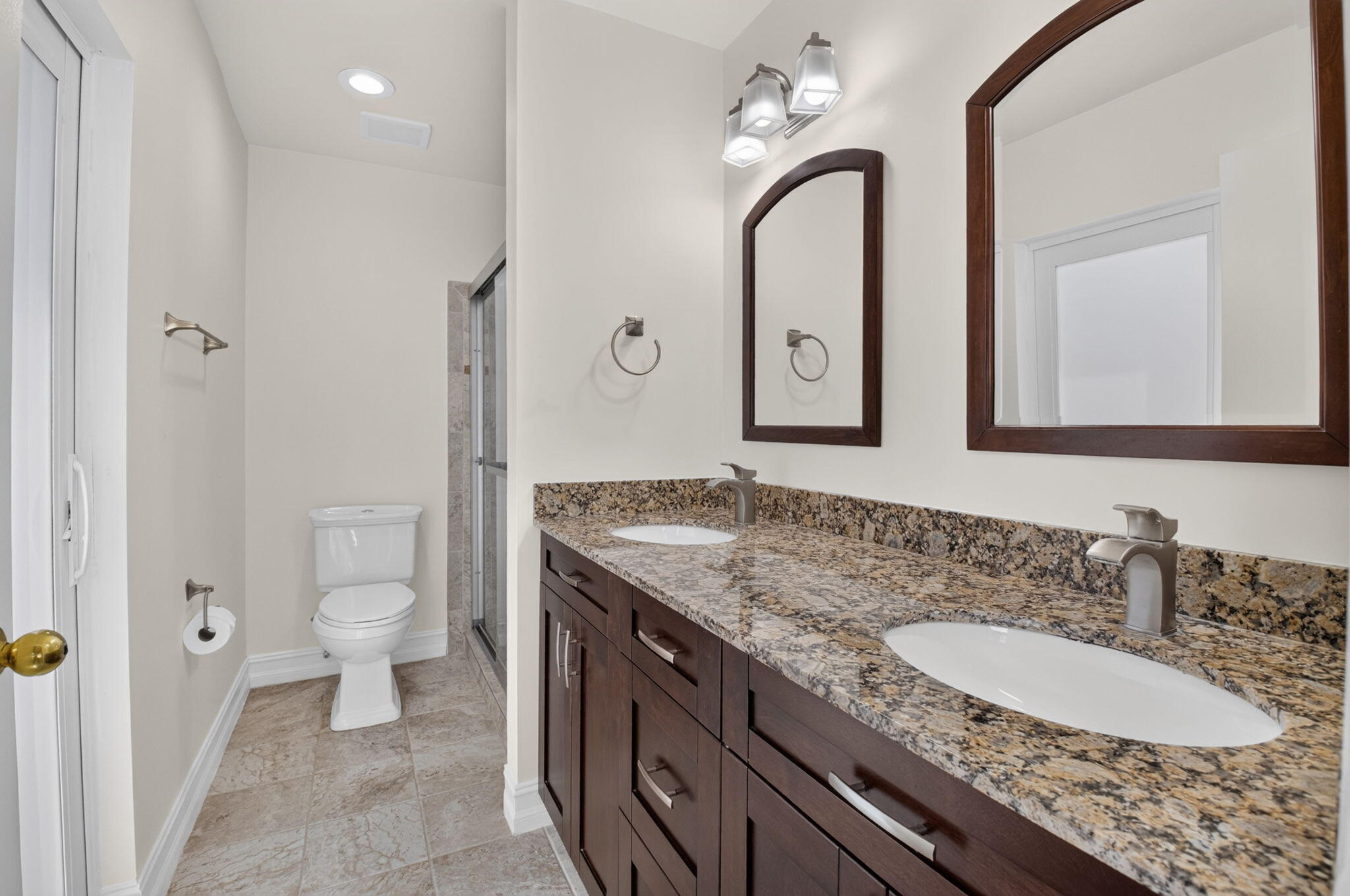 21070 Woodspring Avenue Boca Raton, FL 33428 - Photo 17 of 30 a bathroom with a granite countertop sink a toilet and a mirror