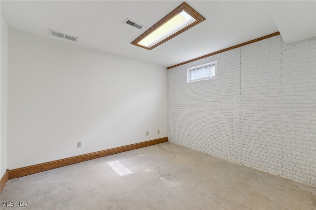 45230 Cemetery Road Wellington, OH 44090 - Photo 30 of 50 Basement featuring brick wall and baseboards