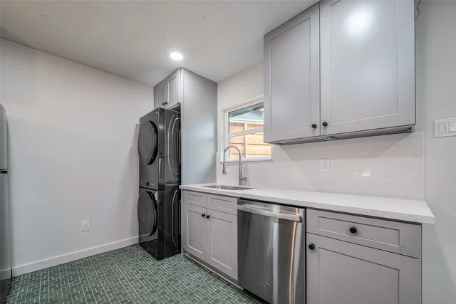a kitchen with stainless steel appliances granite countertop a sink and a refrigerator